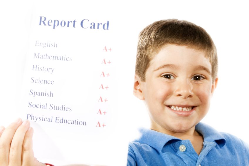 4982659 - stock photo of child holding report card, all a+, isolated on white